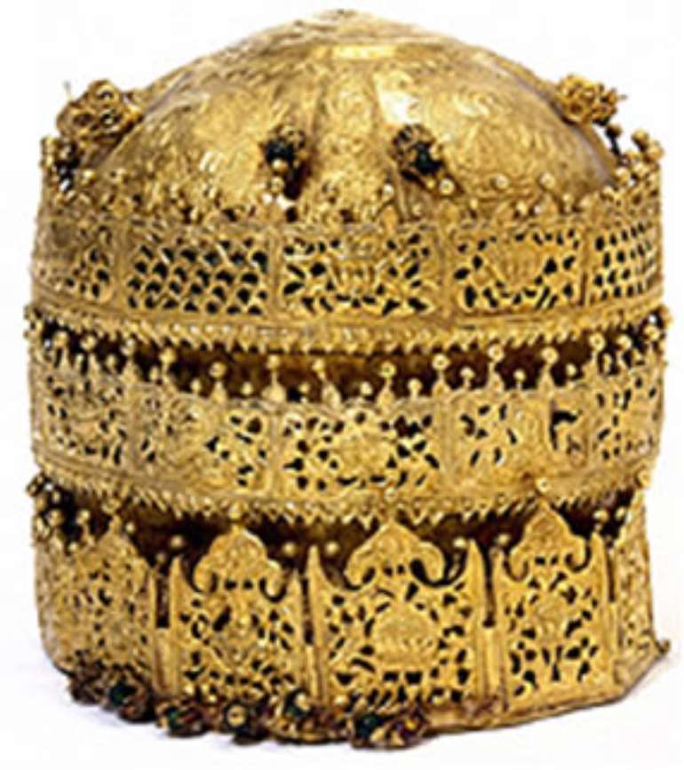 Crown of Tewodros II, Ethiopia, the Victoria and Albert Museum, London, United Kingdom.  Looted during the invasion of Magdala in 1868 by a British Punitive Expedition army. The crown is labled at the Victoria and Albert as the Crown of the Archbishop Abune Selam.” With typical colonialist and imperialist arrogance, this 18 karat gold crown was described as “barbaric” but still kept by the British.